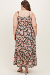 woman wearing a floral maxi maternity dress with a smocked back and tiered hem, showing a baby bump