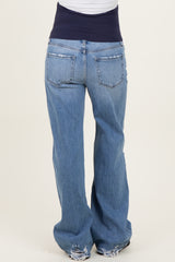 woman wearing distressed blue maternity jeans with a navy waistband, viewed from the back