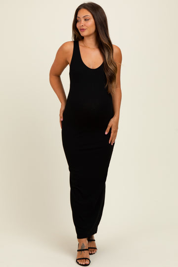 woman wearing a black ribbed sleeveless maternity maxi dress and showing her baby bump