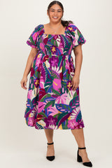 plus size woman wearing a colorful floral print midi dress with puff sleeves and a smocked bodice
