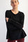 woman wearing a black long sleeve athletic top with a relaxed fit and raglan sleeves