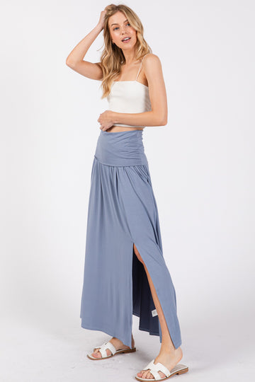 woman wearing a light blue maxi skirt with side slit and a white camisole top