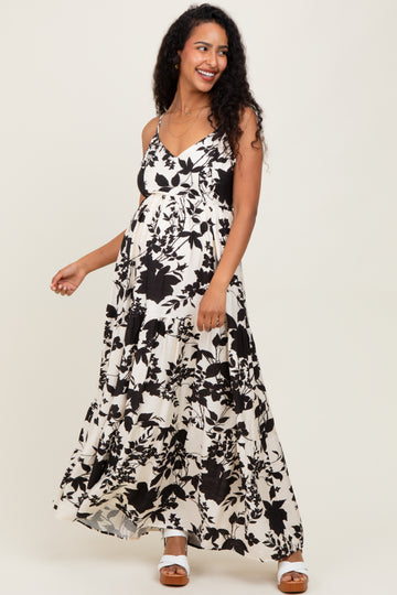 woman wearing a black and white floral maternity maxi dress with adjustable straps and a baby bump visible