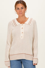 woman wearing a cream and brown striped sweater with a collar and button details