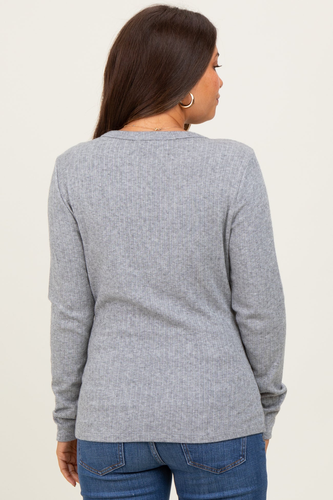 woman wearing a grey ribbed long sleeve maternity top viewed from the back