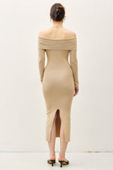 woman wearing a ribbed off-the-shoulder beige dress with long sleeves and back slit detail