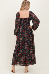 woman wearing a floral maxi dress with long sleeves and a tiered skirt, showing the back view