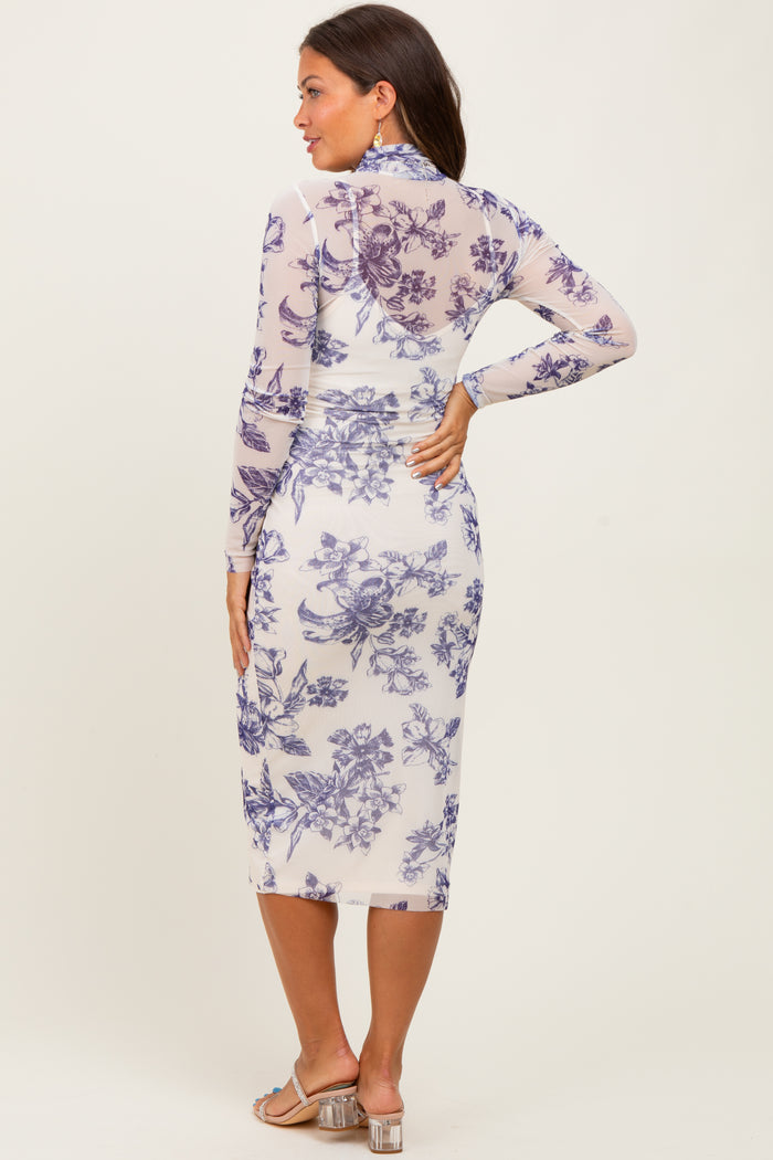 woman wearing a floral long sleeve maternity dress that hugs her baby bump, featuring a midi length and a form-fitting silhouette