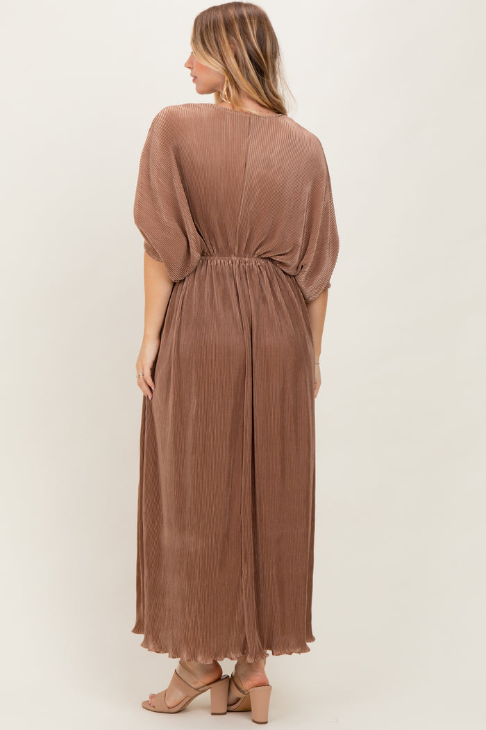 woman wearing a long brown pleated maxi dress with an elastic waistband, shown from the back