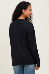 woman wearing a black long sleeve maternity top, showing the back view with relaxed fit and round neckline