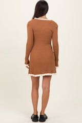 woman wearing a brown ribbed long sleeve dress with a ruffled hem and back detail