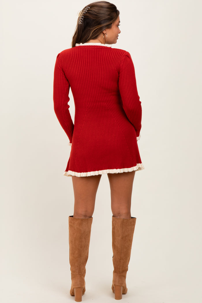 woman wearing a red ribbed maternity dress with a flared hem and long sleeves