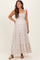 woman wearing a light beige floral print maternity maxi dress with square neckline and tie shoulder straps, baby bump visible