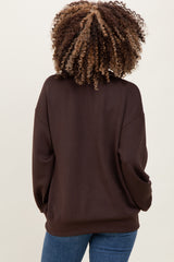 woman wearing a dark brown maternity sweatshirt with a relaxed fit and long sleeves, viewed from the back