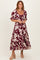 woman wearing a burgundy floral tiered maxi dress with puff sleeves and a square neckline