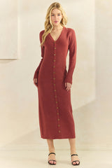 woman wearing a rust-colored ribbed long sleeve button-up dress with a v-neckline and a fitted silhouette