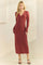 woman wearing a rust-colored ribbed long sleeve button-up dress with a v-neckline and a fitted silhouette