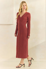 woman wearing a rust long sleeve ribbed knit maxi dress with buttons down the front and black strappy heels