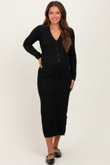 woman wearing a black long sleeve maternity cardigan dress with buttons and a visible baby bump