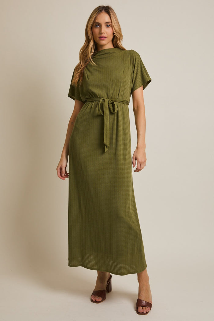 woman wearing an olive green short sleeve maxi dress with a belt and a ribbed texture