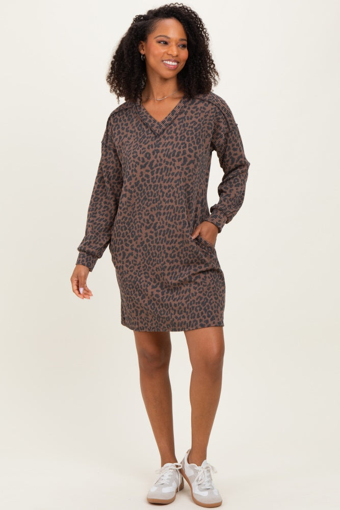 woman wearing a brown leopard print long sleeve dress with a v-neck and pockets