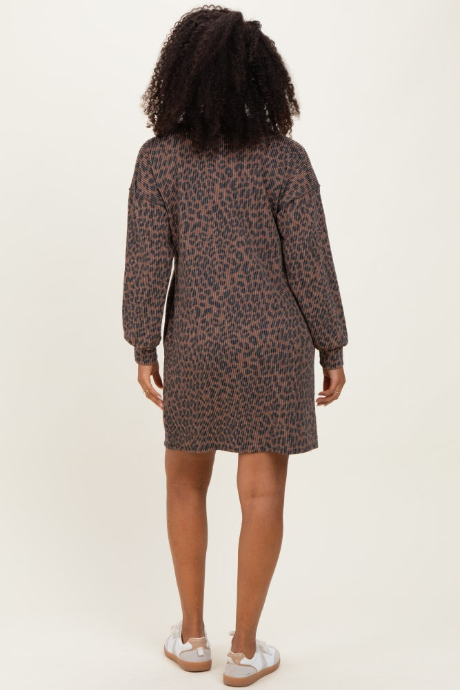 woman wearing a brown leopard print long sleeve dress from the back, with styled curly hair