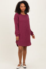 woman wearing a burgundy ribbed sweater dress with long sleeves and side slits