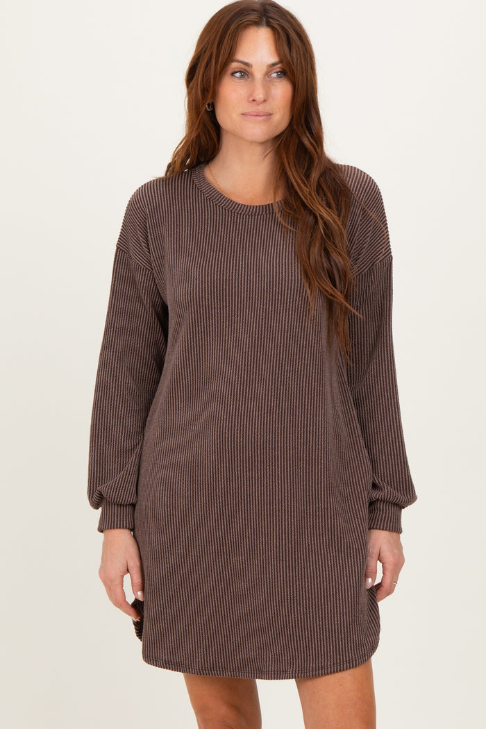 woman wearing a brown ribbed long sleeve oversized dress with a round neckline