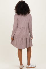 woman wearing a mauve striped long sleeve dress with a flared ruffle hem and paired with white sneakers