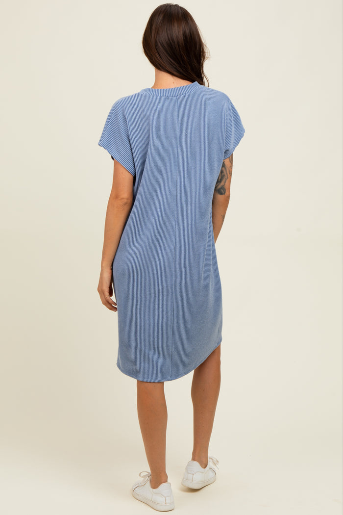 woman wearing a blue striped short sleeve midi dress, viewed from the back