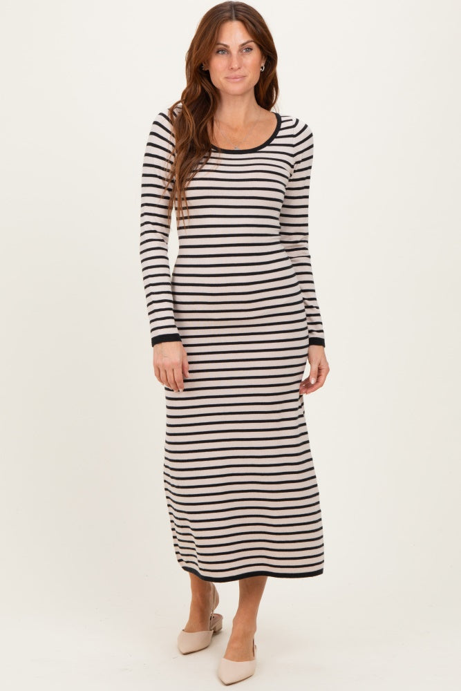 woman wearing a long sleeve striped maxi dress in black and cream with a fitted silhouette