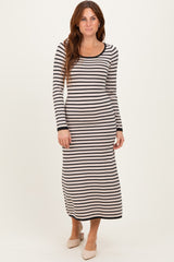 woman wearing a long sleeve striped maxi dress in black and cream with a fitted silhouette