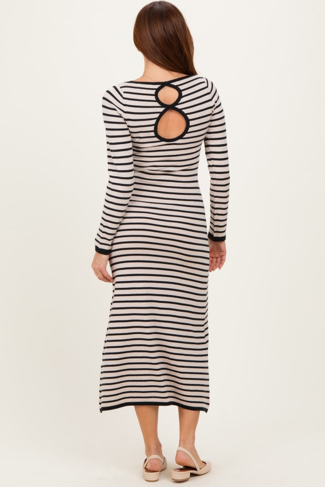 woman wearing a striped long sleeve midi dress with a unique back cutout detail