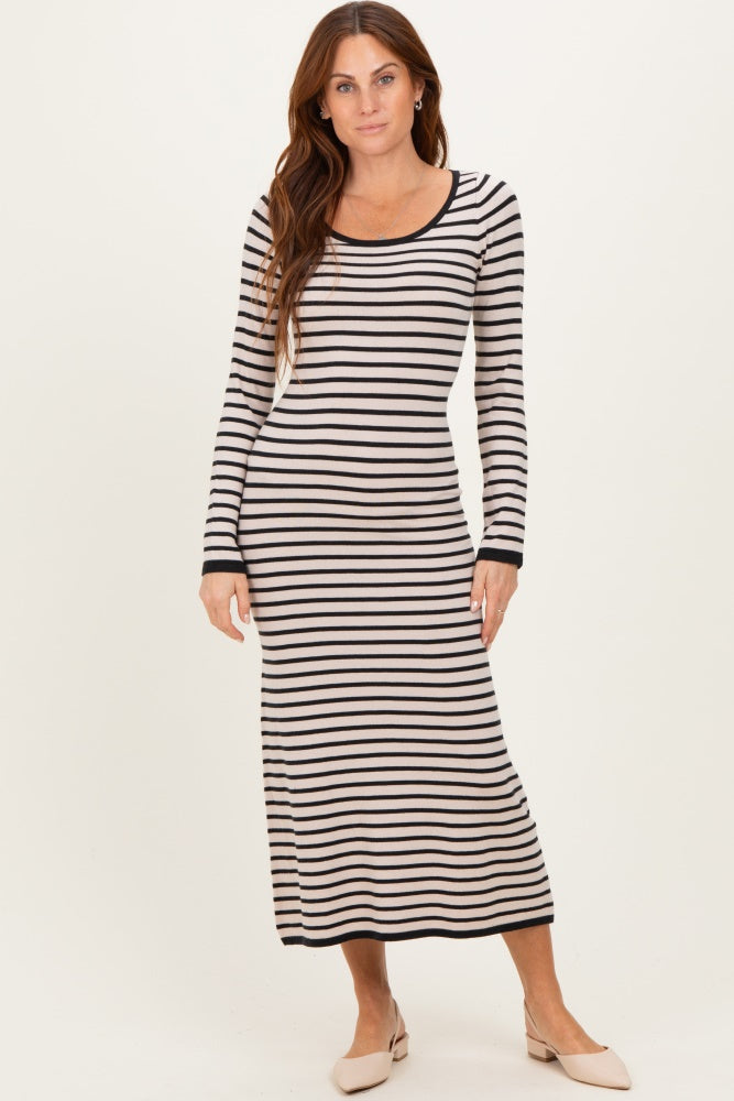 woman wearing a cream and black striped long sleeve maxi dress with a scoop neckline and fitted silhouette
