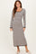 woman wearing a cream and black striped long sleeve maxi dress with a scoop neckline and fitted silhouette