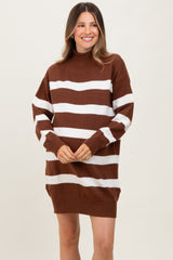 woman wearing a brown and white striped maternity sweater dress with a high neckline and relaxed fit