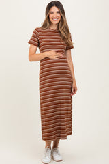 woman wearing a rust and cream striped maternity dress and holding her baby bump
