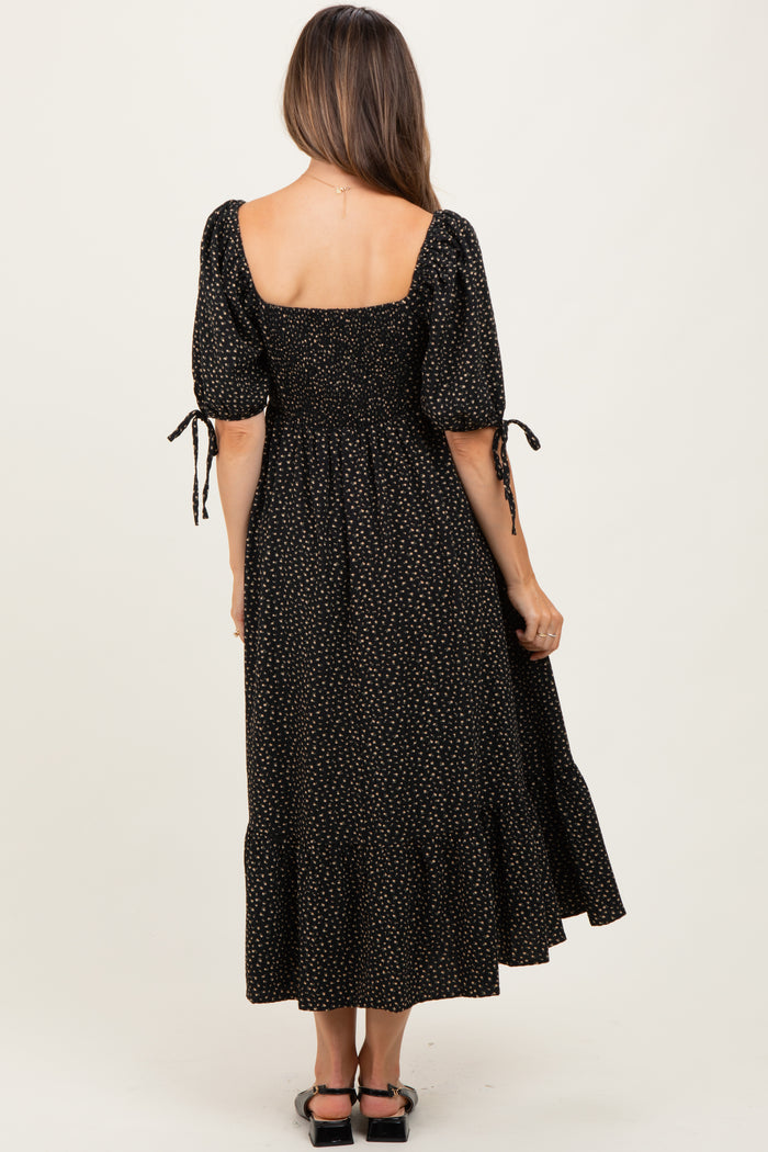 maternity wear black polka dot maxi dress with puff sleeves and tie details, shown from the back