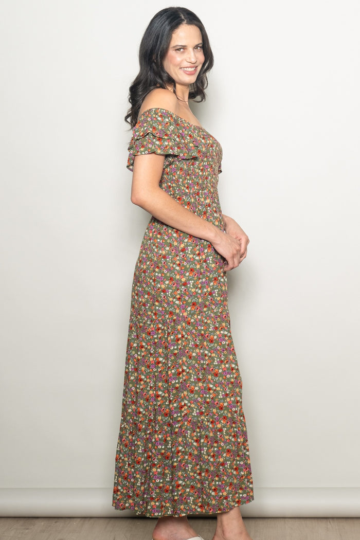 woman wearing a brown floral off-the-shoulder maxi dress with ruffled sleeves and a fitted bodice