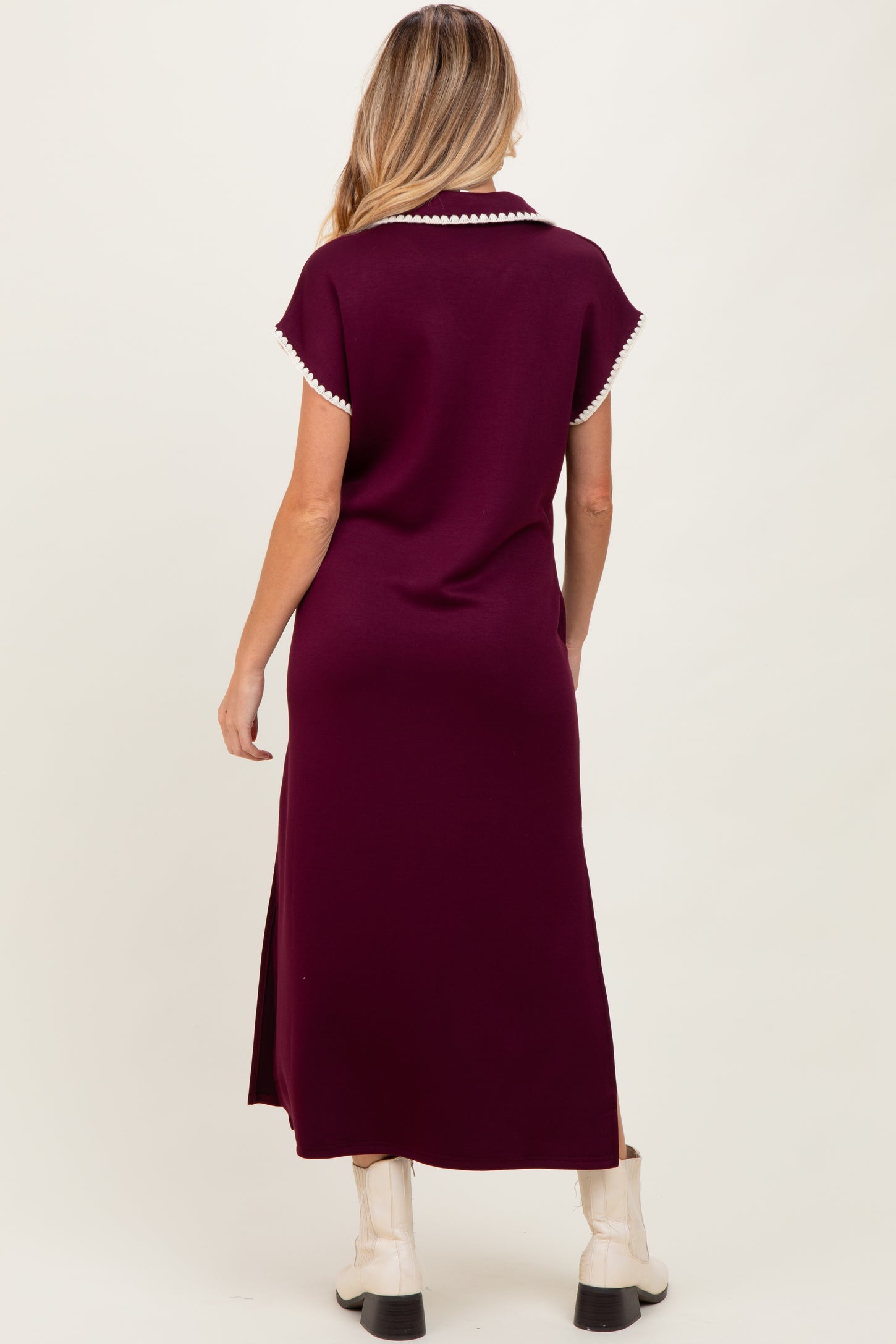 woman wearing a burgundy maternity dress with collar and pearl detailing, shown from the back