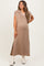 woman wearing a taupe maternity maxi dress with a v-neck and side slits, showing her baby bump