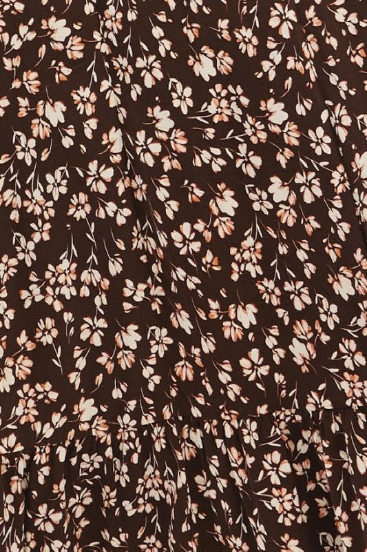 brown floral print dress with small white and peach flowers and a tiered design
