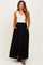woman wearing a black maternity maxi skirt with pockets and button details
