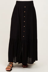 maternity wear black tiered maxi skirt with button detailing and an elastic waistband, styled with sandals