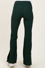 woman wearing green maternity flared pants with a high waistband and a fitted style, shown from the back