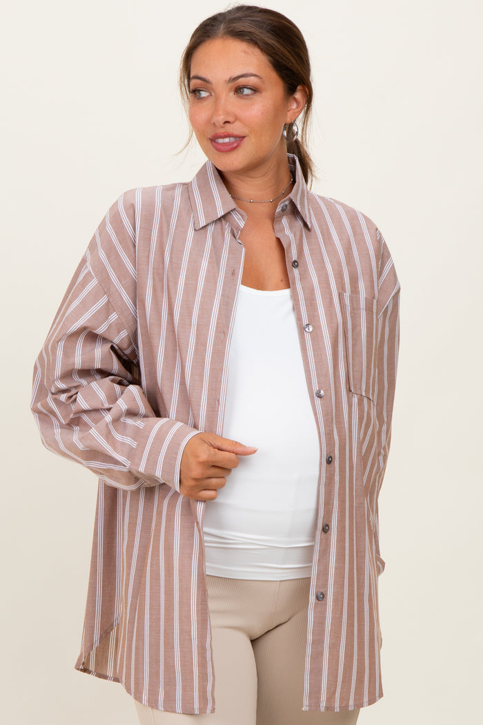 woman wearing a brown striped maternity button-up shirt with a white tank underneath and a visible baby bump