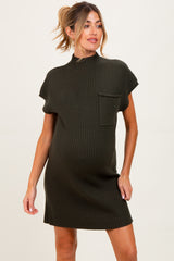 woman wearing a dark green short sleeve ribbed maternity dress with a pocket and visible baby bump