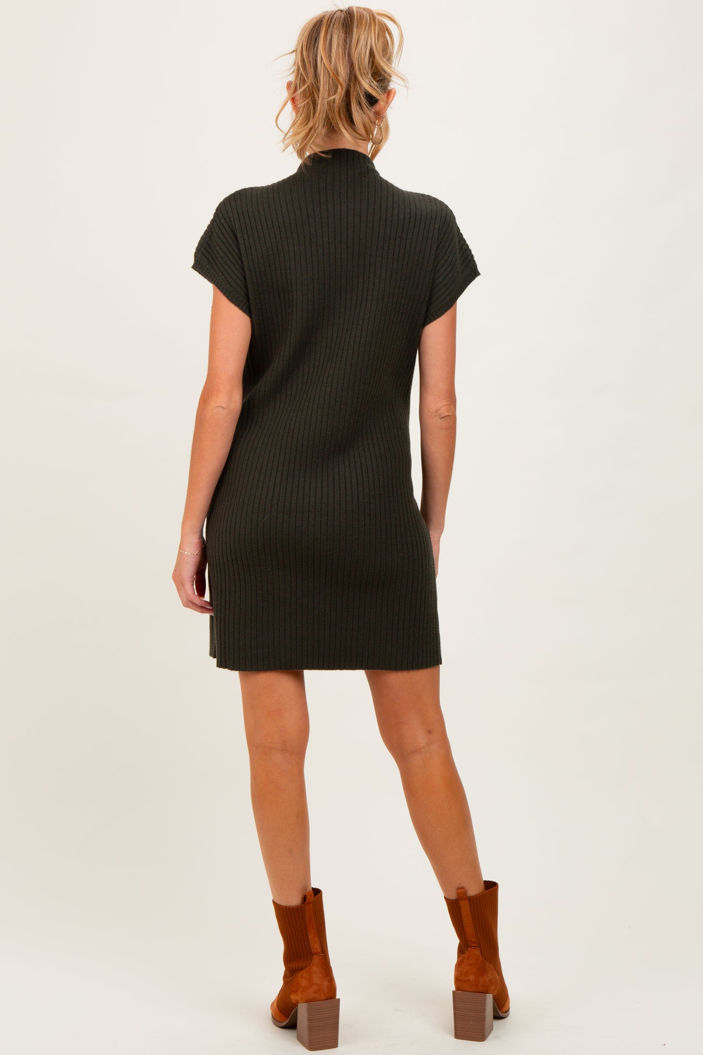 woman wearing a dark green ribbed maternity dress with short sleeves and a fitted silhouette