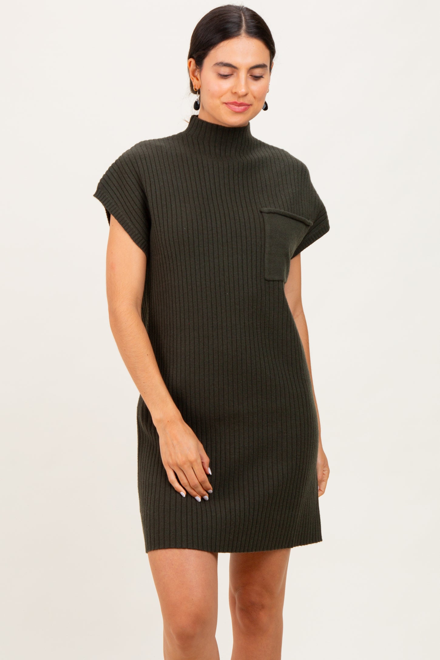 woman wearing a dark green ribbed short sleeve dress with a mock neck and a chest pocket