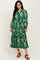 woman wearing a green floral printed maxi dress with long sleeves and a tiered skirt